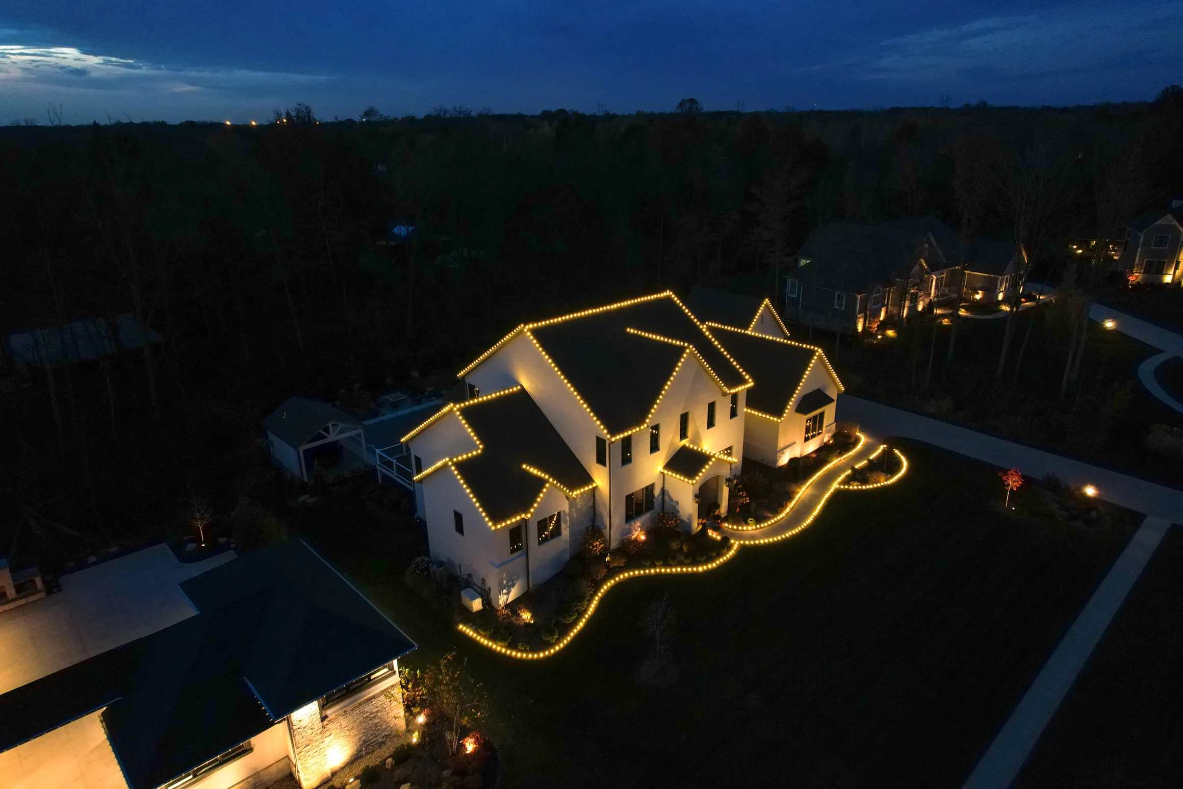 Beautiful Christmas light installation with warm white lights on residential home