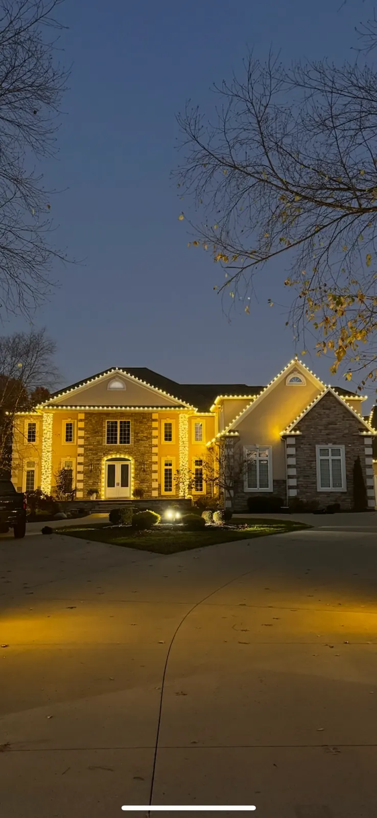Front elevation of an estate with professional Christmas roofline lighting