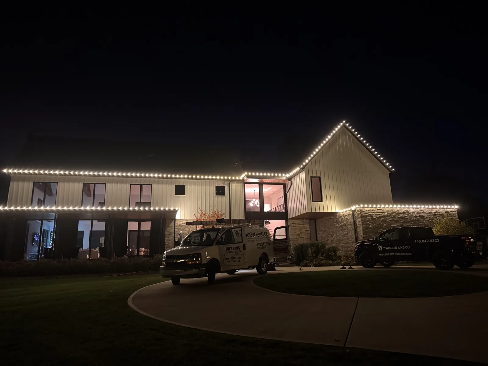 Warm white Christmas lighting on a modern farmhouse