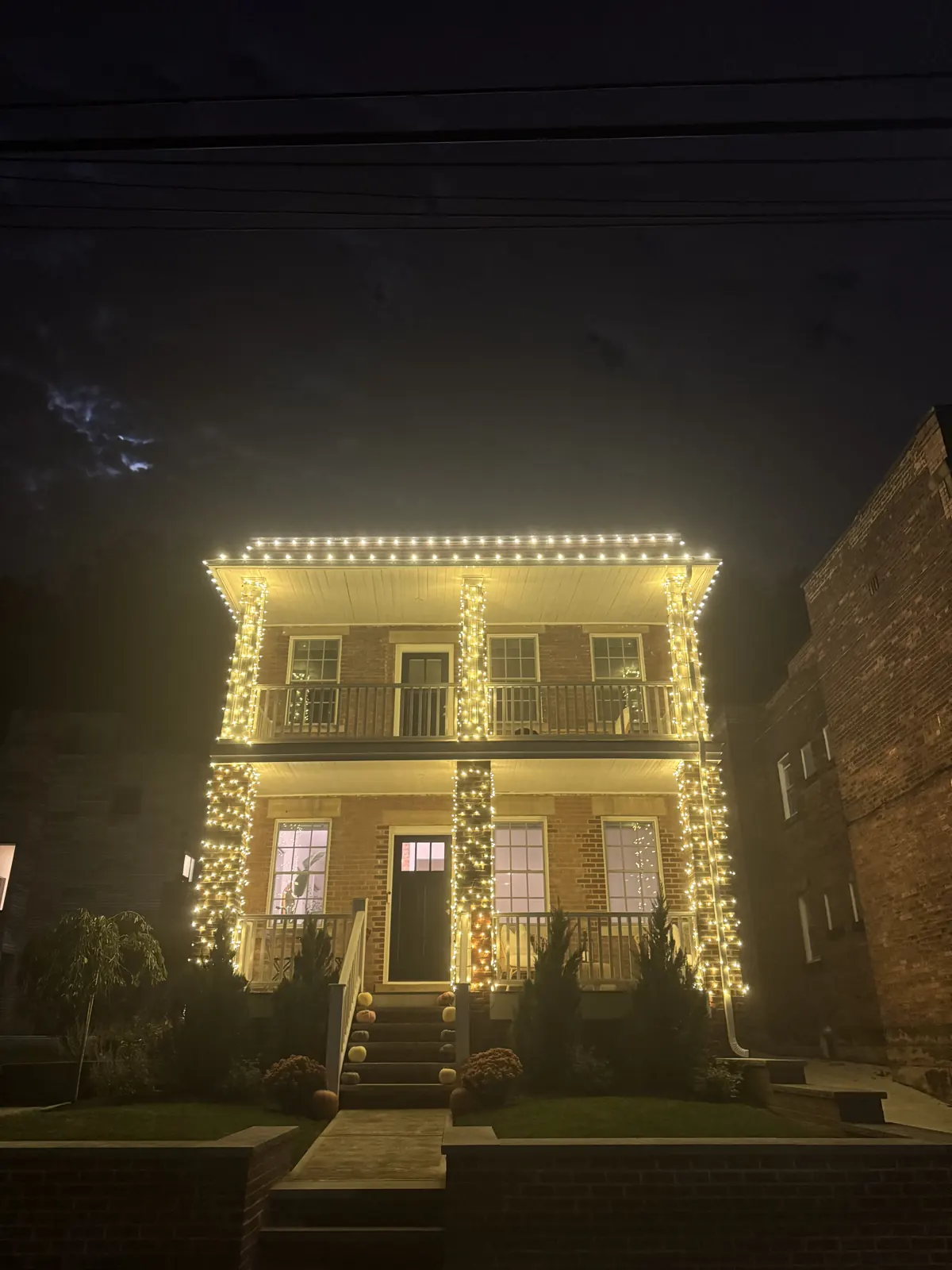 Christmas roofline and column lighting on a two-story home